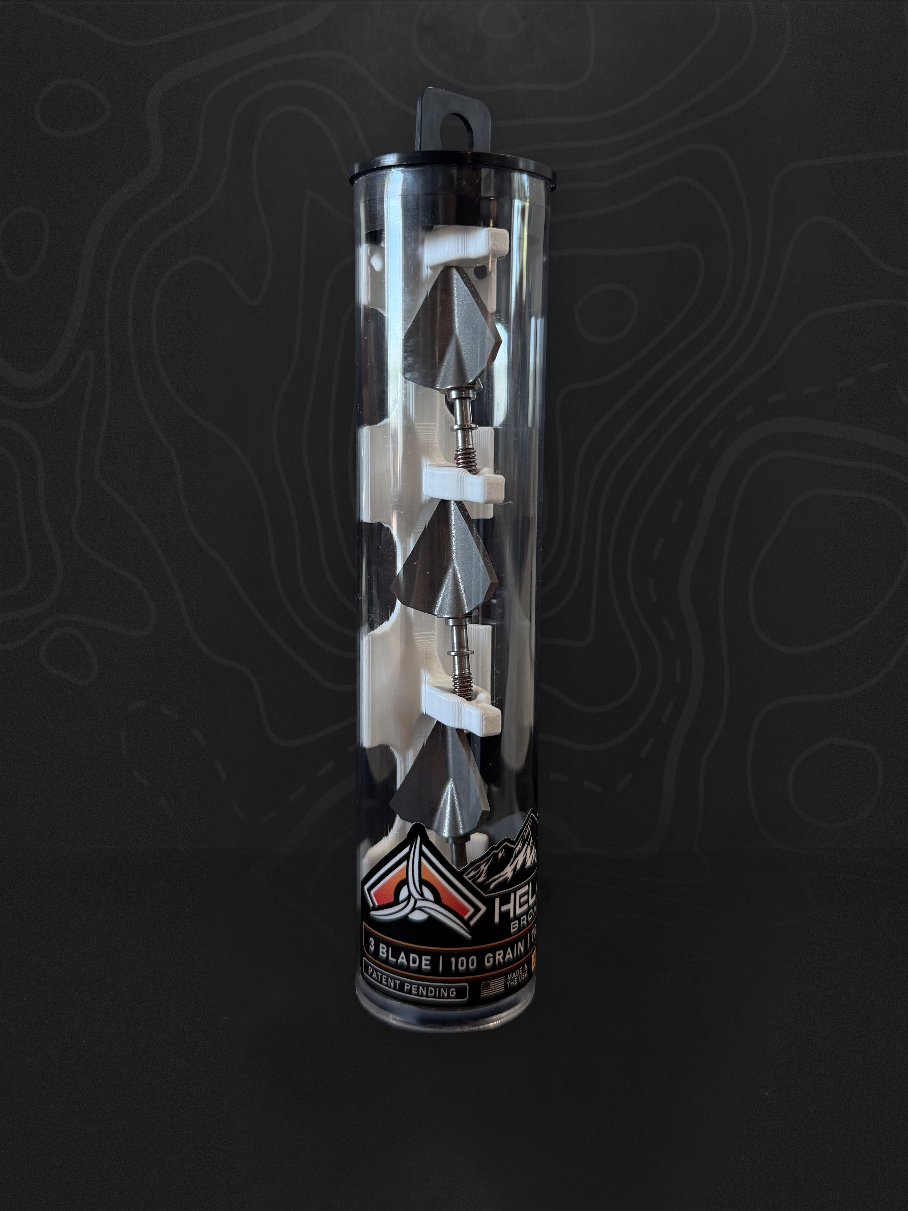 Three Helakill HXR 100-grain fixed-blade broadheads in their clear carrying tube