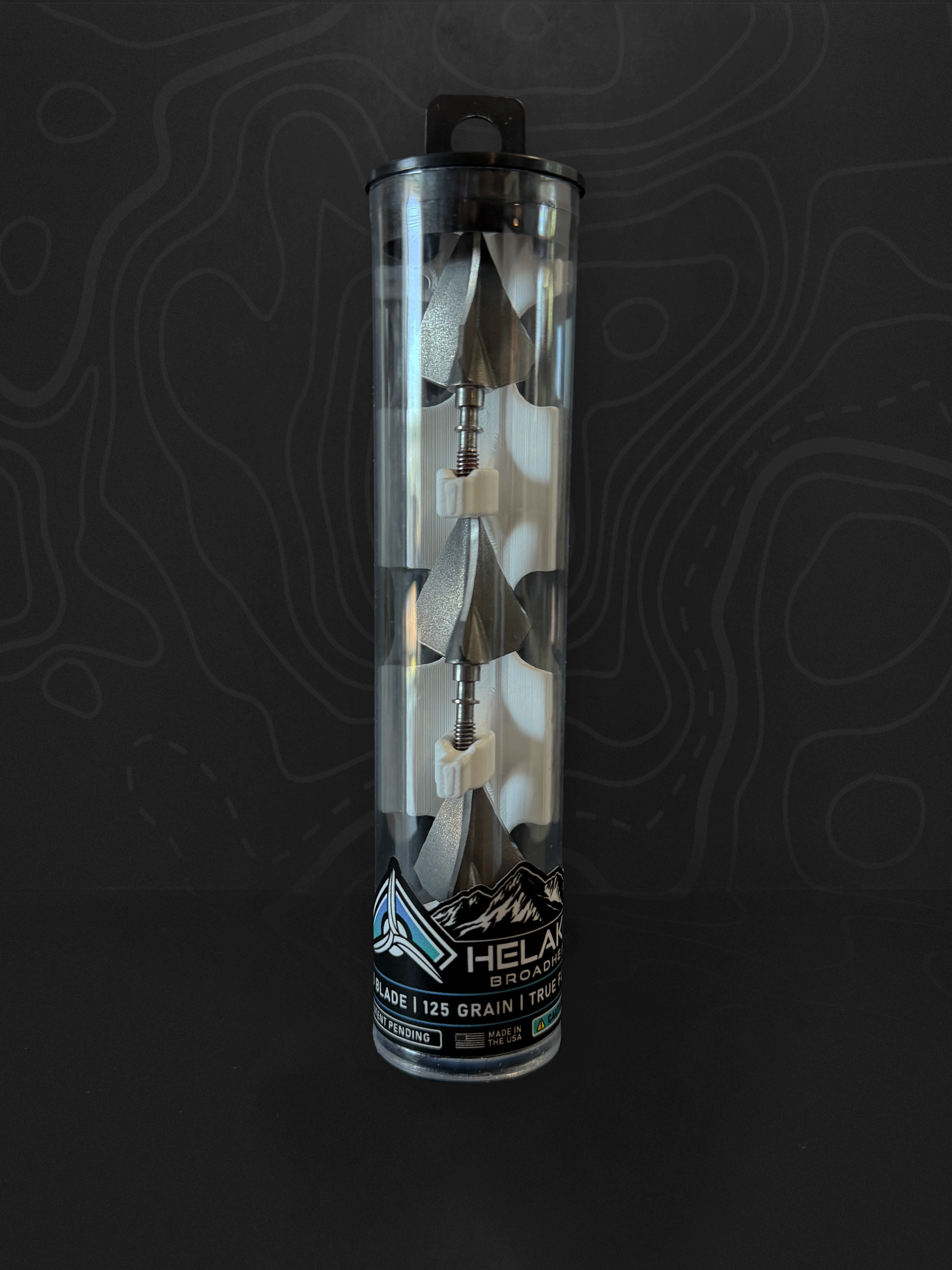 Three Helakill HXR 125-grain fixed-blade broadheads in their clear carrying tube