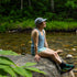 Womens microweight tank top super light merino wool for summer, woman sitting on a rock beside a stream