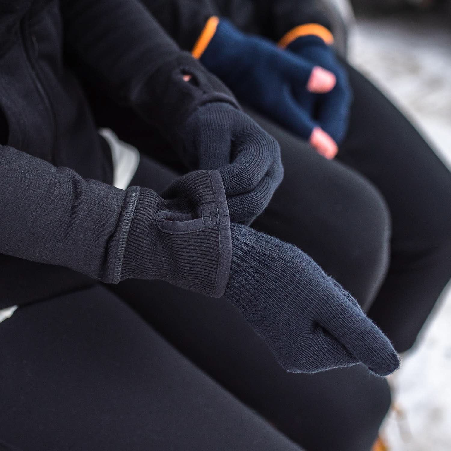 Close-up of a person pulling on lightweight merino glove liners