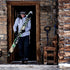 A man comes out of a cabin with skis in hand. The man is modeling the heavyweight brushed wool Kodiak Fleece Hoodie, crafted with thumbholes and a drawstring to bundle you up for wicked cold days!