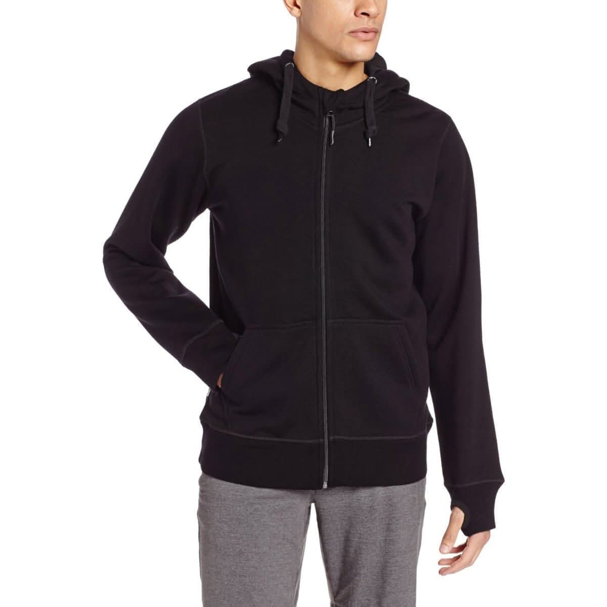 One hand in pocket a man models the heavyweight brushed wool Kodiak Fleece Hoodie, crafted with thumbholes and a drawstring to bundle you up for wicked cold days!