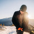 Expedition - Men's Wool Full Zip Wilderness - Minus33 Merino Wool Clothing, man fastening a black full-zip layer at a snowy mountain sunrise