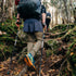 Minus33 Merino Wool Clothing Kancamagus Men's Midweight Wool Bottom thermal baselayer, rear view of hiker climbing a forest trail with trekking poles