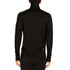A man models the merino wool midweight quarter zip sweater, complete with flat-lock seams and thumbholes.