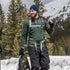 A man models the merino wool midweight quarter zip sweater, complete with flat-lock seams and thumbholes, front view outdoors