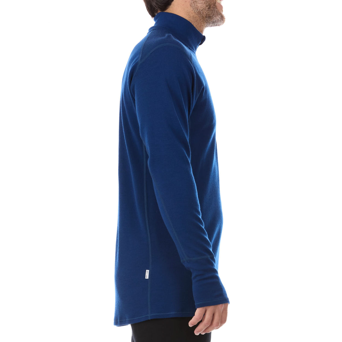 A man models the merino wool midweight quarter zip sweater, complete with flat-lock seams and thumbholes, side view