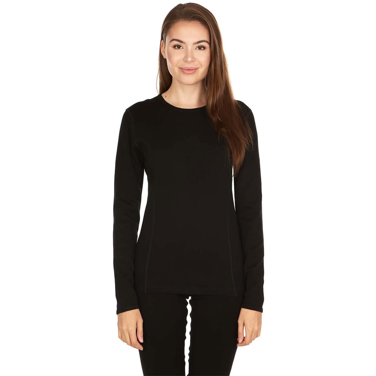 A woman models the one hundred percent merino wool heavyweight women's base layer crew top. This super soft top has a princess cut style for a more flattering fit.