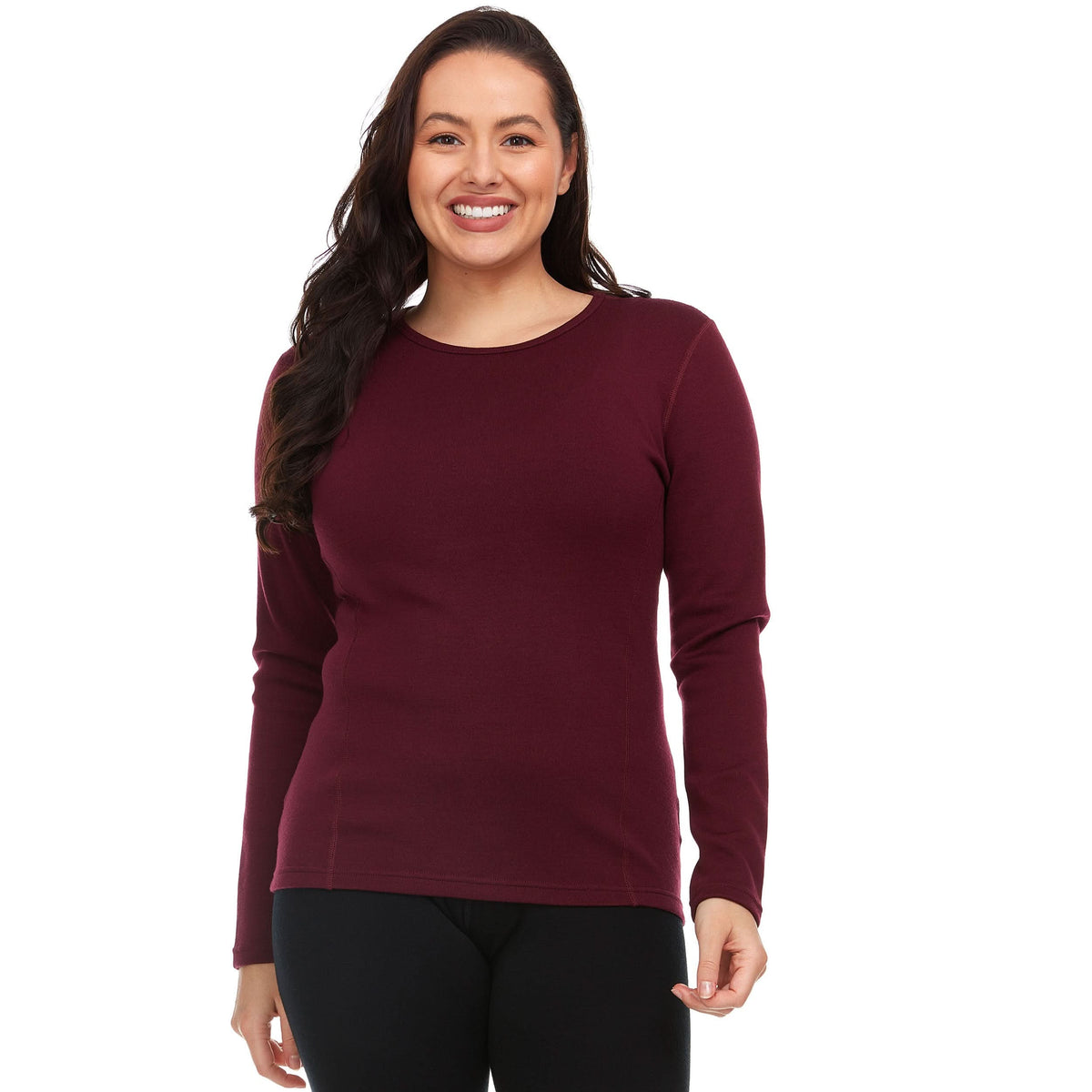 A woman models the one hundred percent merino wool heavyweight women's base layer crew top. This super soft top has a princess cut style for a more flattering fit. Front view 1.