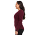 A woman models the one hundred percent merino wool heavyweight women's base layer crew top. This super soft top has a princess cut style for a more flattering fit.