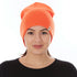 Front view of a female model wearing a blaze orange heavyweight 100% merino wool beanie with a folded cuff