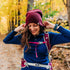 A woman on the trail models a heavyweight, super soft, one hundred percent merino wool beanie. This heavyweight beanie is the warmest hat that we offer, perfect for hiking through the White Mountains, or sitting at a bonfire in January.