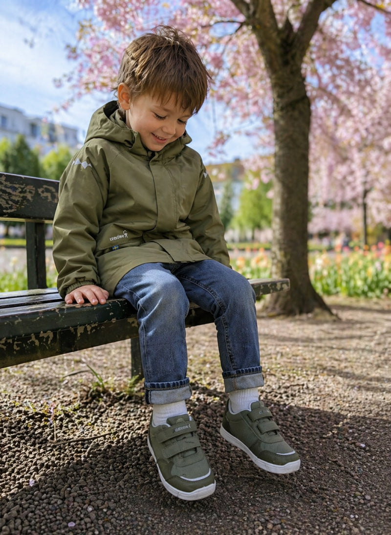 Child wearing green Isbjörn FOXY AllWeather Low sneakers outdoors