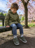 Child wearing green Isbjörn FOXY AllWeather Low sneakers outdoors