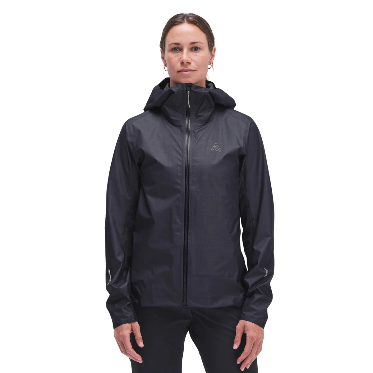 A woman modeling a black hooded zip-up jacket against a plain white background.