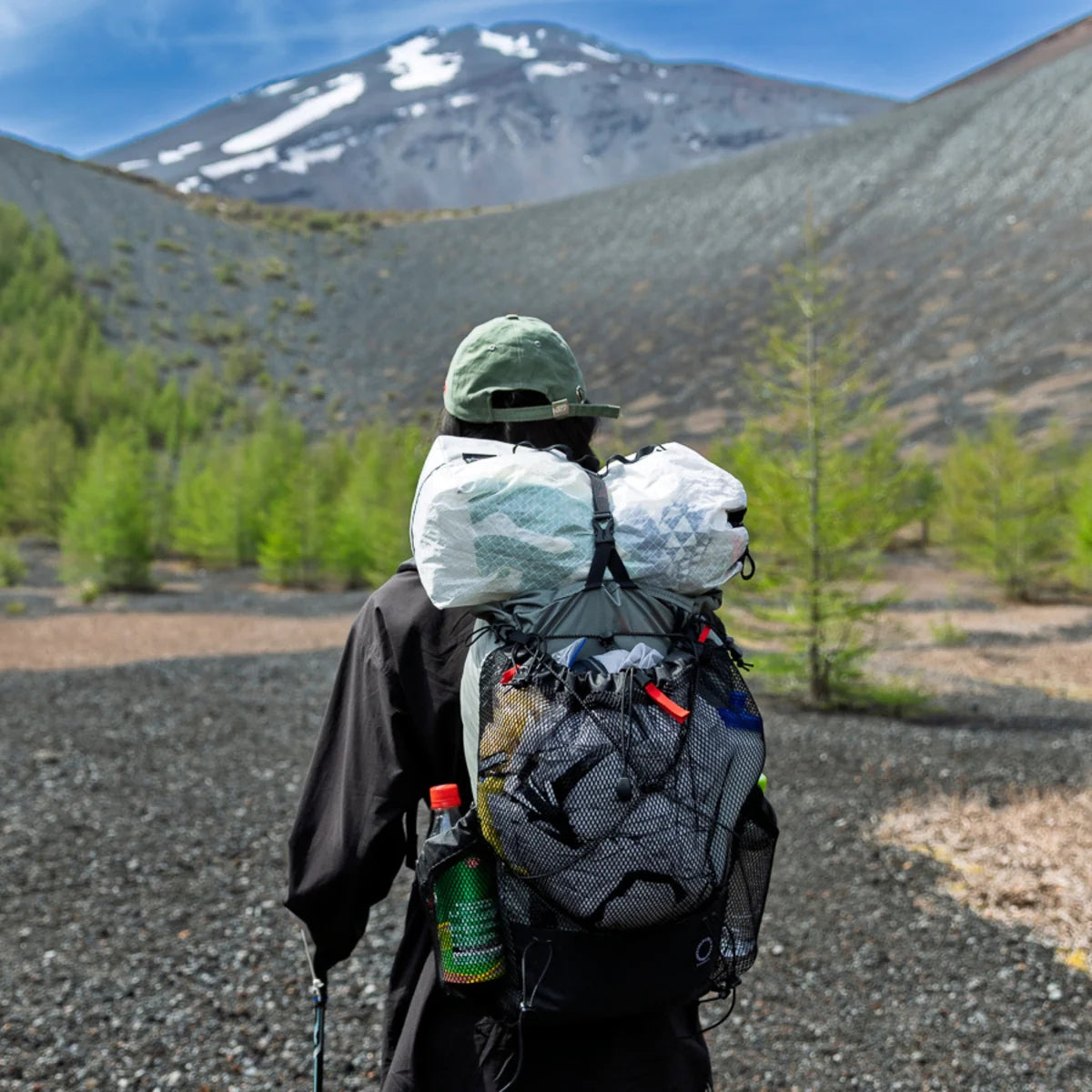 Person with a large backpack in a mountainous landscape