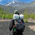 Person with a large backpack in a mountainous landscape