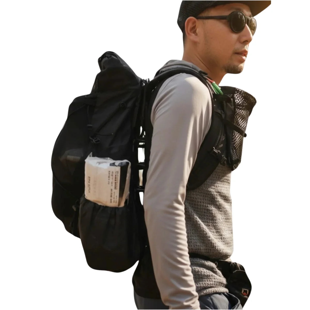 A man wearing a black outdoor backpacking backpack with side pockets, shown from the side against a plain white background.