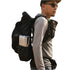 A man wearing a black outdoor backpacking backpack with side pockets, shown from the side against a plain white background.