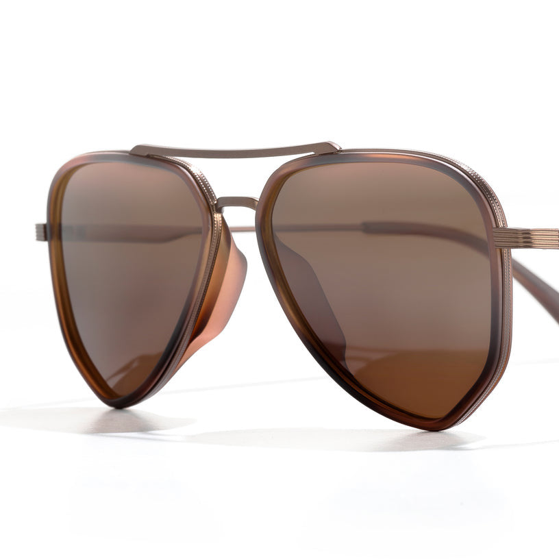 Sunski Astra Polarized Sunglasses - Tortoise Amber - Brown sunglasses with a reflective lens on a white background